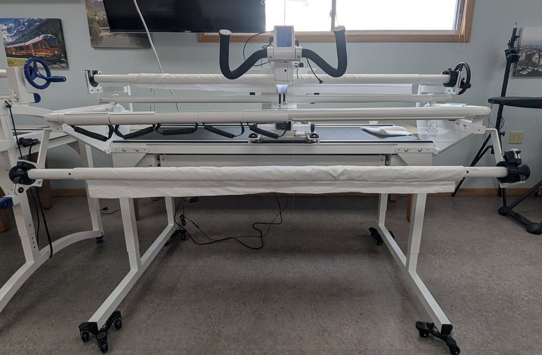 Large white crafting machine in a room with a window and other equipment.