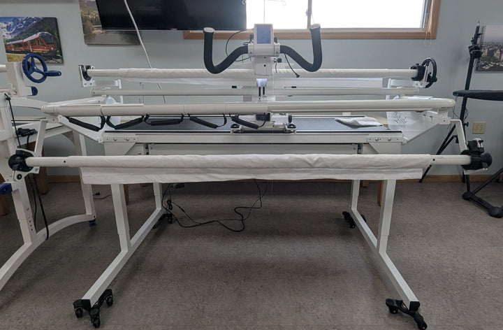 Large white crafting machine in a room with a window and other equipment.